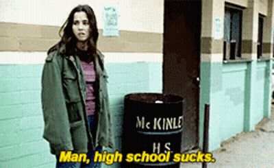 A Woman Standing Next To A Barrel That Says Mckinle Hs On It GIF