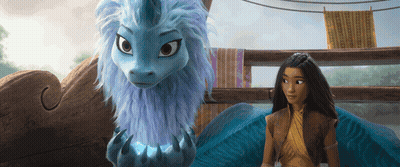 A Woman Standing Next To A Blue Dragon With A Unicorn Horn GIF