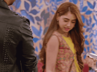 A Woman Standing Next To A Man In A Black Leather Jacket GIF