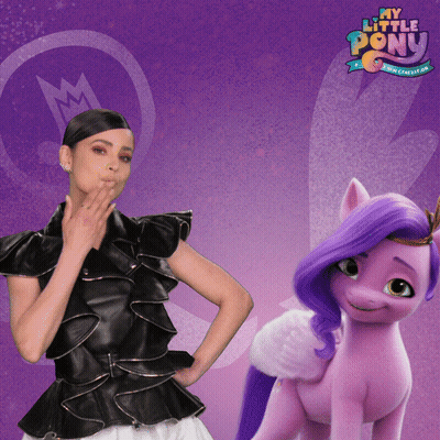 A Woman Standing Next To A Purple Pony That Says My Little Pony On It GIF