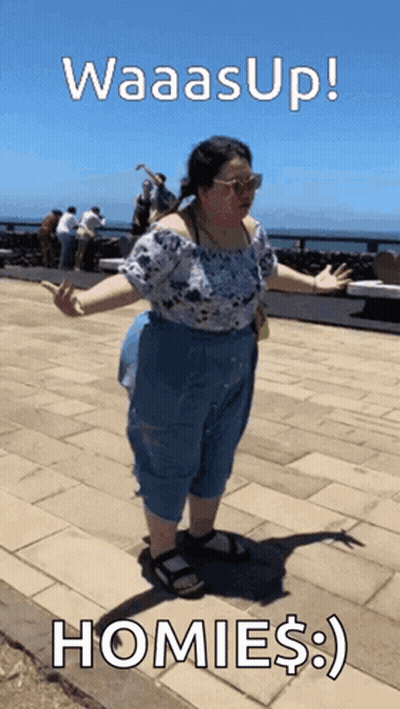 A Woman Standing On A Sidewalk With The Words Waasup Homies GIF