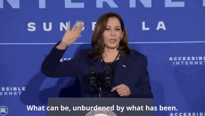 A Woman Stands At A Podium With The Words " What Can Be Unburdened By What Has Been " GIF