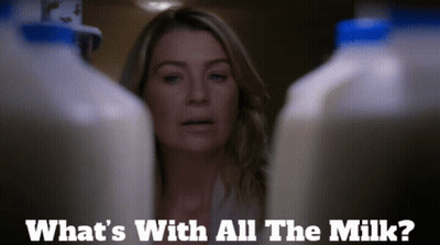 A Woman Stands Between Two Bottles Of Milk And Says What 'S With All The Milk ? GIF