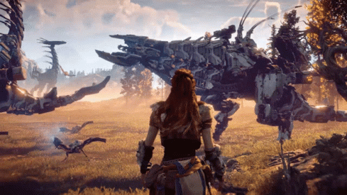 A Woman Stands In A Field Looking At A Robot That Says ' Horizon Zero Dawn ' On The Side GIF