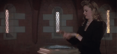 A Woman Stands In Front Of A Baptismal Font GIF