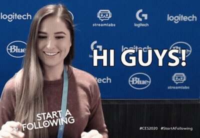 A Woman Stands In Front Of A Blue Background That Says Logitech And Blue GIF