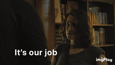 A Woman Stands In Front Of A Bookshelf With The Words It 'S Our Job Below Her GIF