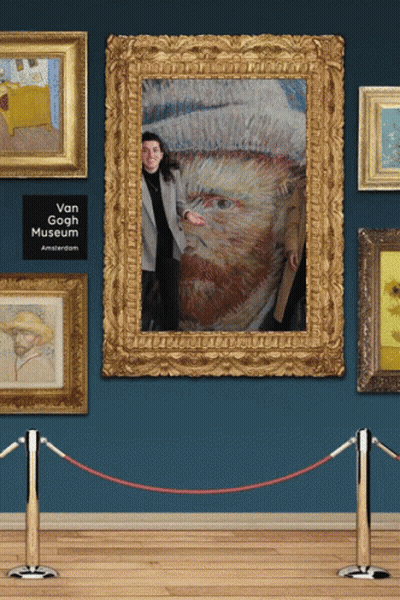 A Woman Stands In Front Of A Framed Portrait Of Vincent Van Gogh GIF