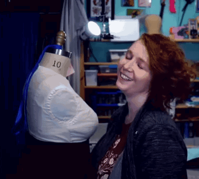 A Woman Stands In Front Of A Mannequin With The Number 10 On It GIF