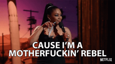 A Woman Stands In Front Of A Microphone And Says " Cause I 'M A Motherfucking Rebel " GIF