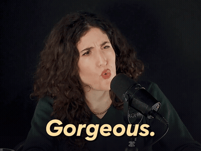 A Woman Stands In Front Of A Microphone With The Word Gorgeous In Yellow GIF