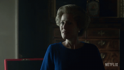 A Woman Stands In Front Of A Netflix Sign GIF