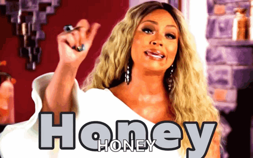 A Woman Stands In Front Of A Poster That Says Honey GIF
