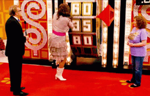 A Woman Stands In Front Of A Scoreboard That Says 60 85 80 GIF