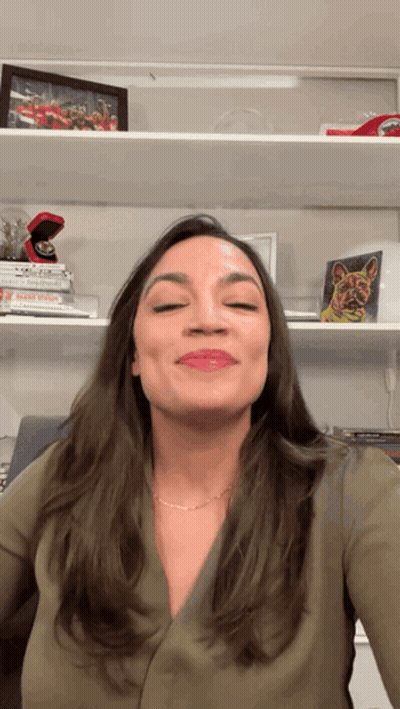 A Woman Stands In Front Of A Shelf With A Picture Of A Ring On It GIF