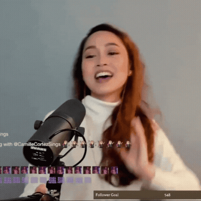A Woman Stands In Front Of A Shure Microphone With A Follower Goal Of 548 GIF