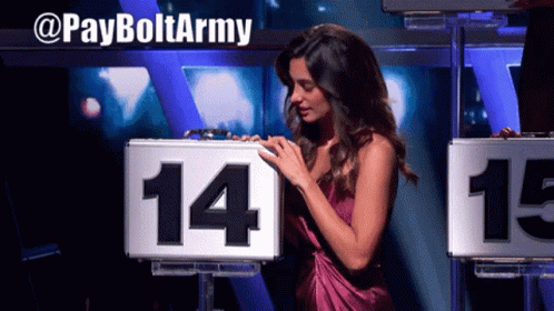 A Woman Stands In Front Of A Sign That Says 14 And 15 GIF