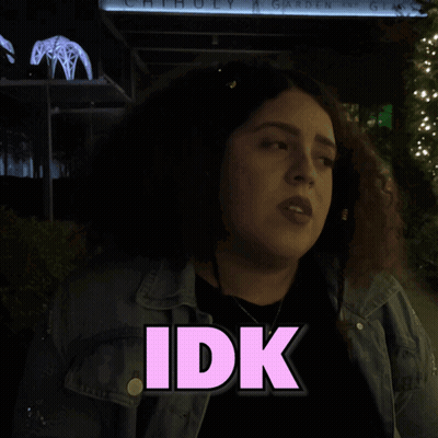 A Woman Stands In Front Of A Sign That Says Anymore On It GIF