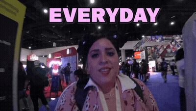 A Woman Stands In Front Of A Sign That Says Everyday On It GIF