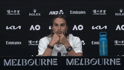 A Woman Stands In Front Of A Sign That Says Melbourne On It GIF