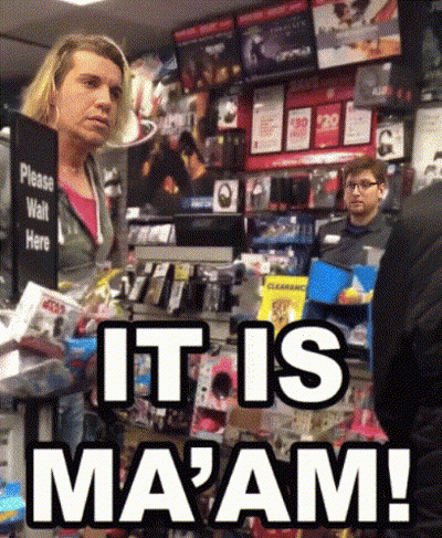 A Woman Stands In Front Of A Sign That Says " Please Wait Here " GIF