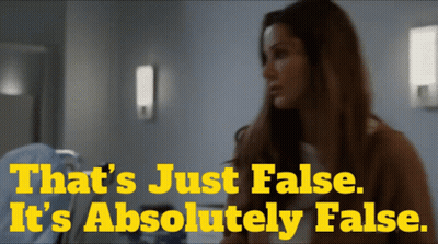 A Woman Stands In Front Of A Sign That Says " That 'S Just False It 'S Absolutely False " GIF