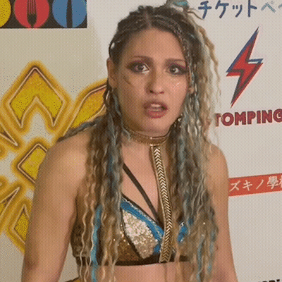 A Woman Stands In Front Of A Sign That Says ' Tomping ' On It GIF