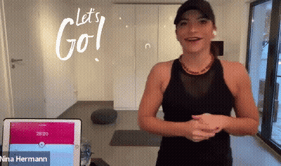 A Woman Stands In Front Of A Tablet With The Words Let 'S Go Written On It GIF