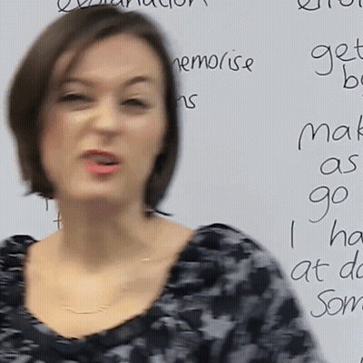A Woman Stands In Front Of A White Board That Says " Make As Go " On It GIF
