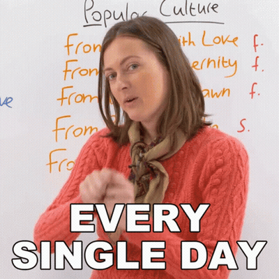 A Woman Stands In Front Of A White Board That Says " Popular Culture " GIF