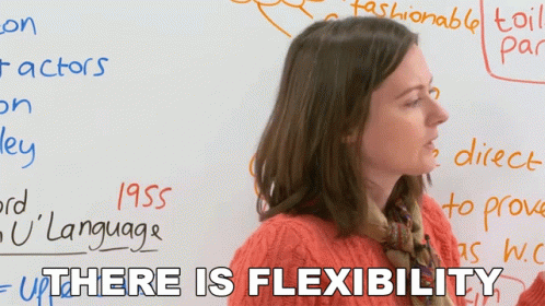 A Woman Stands In Front Of A White Board With The Words " There Is Flexibility " On It GIF
