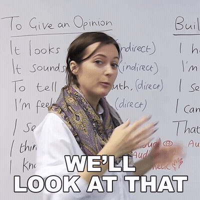 a woman stands in front of a white board with the words " we 'll look at that " written on it