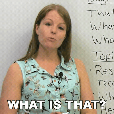 A Woman Stands In Front Of A White Board With The Words What Is That On It GIF