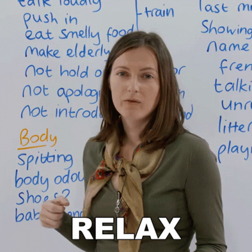 A Woman Stands In Front Of A Whiteboard With The Word Relax Written On It GIF