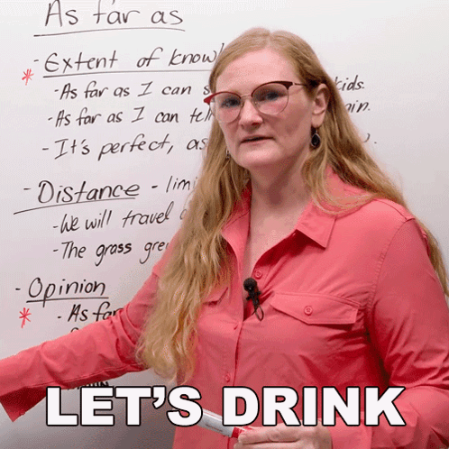 A Woman Stands In Front Of A Whiteboard With The Words Let 'S Drink Written On It GIF