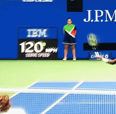 A Woman Stands On A Tennis Court In Front Of A Sign That Says 120 GIF