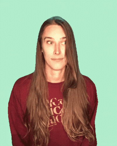 A Woman Sticking Her Tongue Out Wearing A Sweater That Says Coca Cola On It GIF