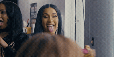 A Woman Sticking Her Tongue Out While Looking In A Mirror GIF