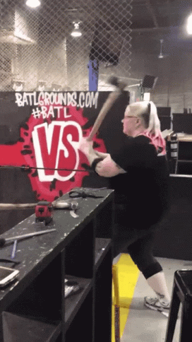A Woman Swings An Axe In Front Of Battlegrounds.com GIF