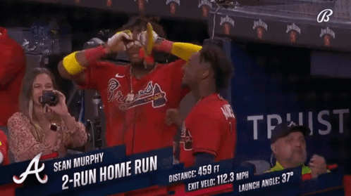 A Woman Takes A Picture Of A Baseball Player Named Sean Murphy In The Dugout GIF