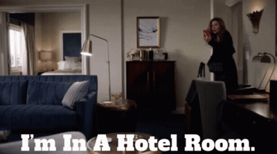 A Woman Taking A Picture In A Hotel Room With The Words I 'M In A Hotel Room GIF