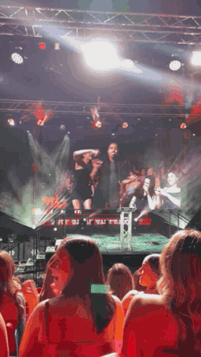 A Woman Taking A Picture Of A Stage With The Word Exit On It GIF