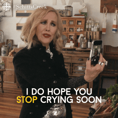 A Woman Taking A Picture Of Herself With The Words I Do Hope You Stop Crying Soon Below Her GIF