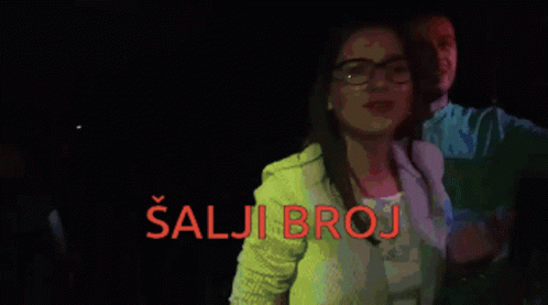A Woman Taking A Picture Of Herself With The Words Salji Broj Written In Red GIF