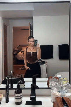 A Woman Taking A Selfie In Front Of A Bathroom Mirror GIF