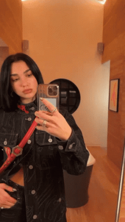 A Woman Taking A Selfie In Front Of A Mirror GIF