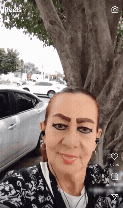 A Woman Taking A Selfie With A Car In The Background And The Word Reels On The Bottom GIF