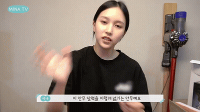 A Woman Talking In Front Of A Vacuum Cleaner That Says Mina Tv On It GIF