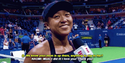 A Woman Talking Into A Microphone On A Tennis Court In Front Of An American Express Sign GIF