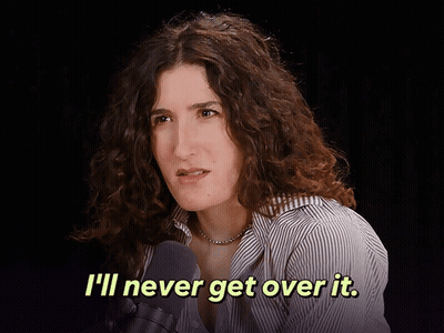 A Woman Talking Into A Microphone With The Words " I 'Ll Never Get Over It " Above Her GIF